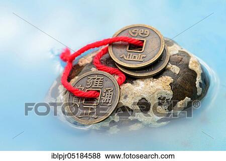 Stock Photo - Chinese lucky coins, on stone. Fotosearch