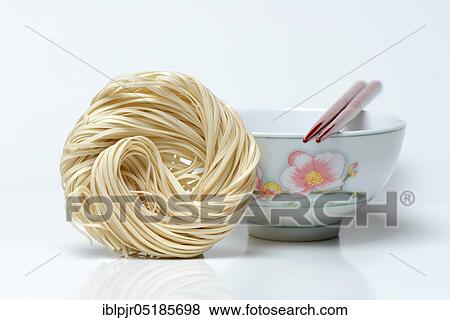 Chinese noodles and bowl with chopsticks, uncooked, nest noodles View Large Photo Image Stock Photo - Chinese noodles and bowl with chopsticks, uncooked, nest noodles. Fotosearch