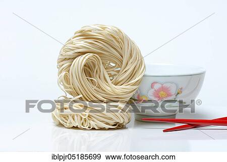 Chinese noodles and bowl with chopsticks, uncooked, nest noodles View Large Photo Image Stock Photo - Chinese noodles and bowl with chopsticks, uncooked, nest noodles. Fotosearch