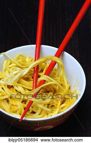 Chinese noodles in bowl with chopsticks, cooked, nest noodles, curry sauce View Large Photo Image Picture - Chinese noodles in bowl with chopsticks, cooked, nest noodles, curry sauce. Fotosearch