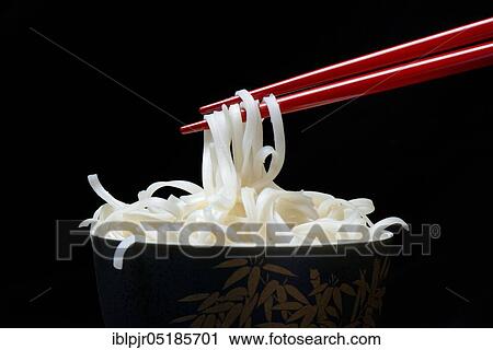 Stock Image - Chinese noodles in bowl with chopsticks, cooked. Fotosearch