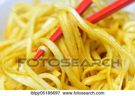 Chinese noodles in bowl with chopsticks, cooked, nest noodles, curry sauce View Large Photo Image Stock Photo - Chinese noodles in bowl with chopsticks, cooked, nest noodles, curry sauce. Fotosearch