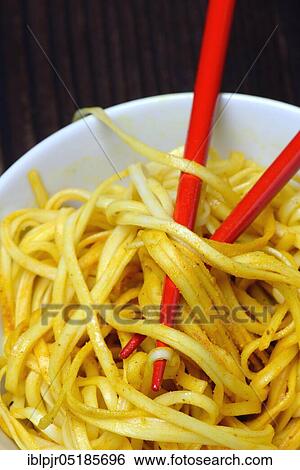 Chinese noodles in bowl with chopsticks, cooked, nest noodles, curry sauce View Large Photo Image Stock Photograph - Chinese noodles in bowl with chopsticks, cooked, nest noodles, curry sauce. Fotosearch
