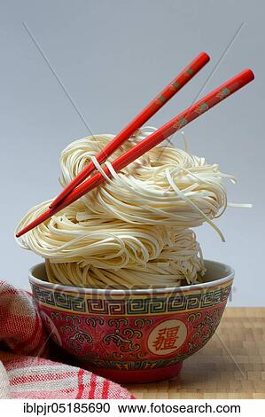 Chinese Yangchun noodles in bowl with chopsticks, uncooked, nest noodles View Large Photo Image Stock Image - Chinese Yangchun noodles in bowl with chopsticks, uncooked, nest noodles. Fotosearch