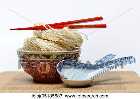 Chinese Yangchun noodles in bowl with chopsticks and porcelain spoon, uncooked, nest noodles View Large Photo Image Stock Photo - Chinese Yangchun noodles in bowl with chopsticks and porcelain spoon, uncooked, nest noodles. Fotosearch