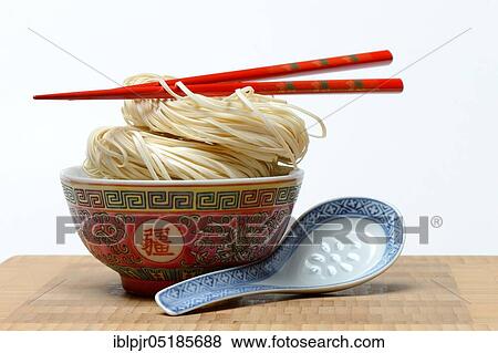 Chinese Yangchun noodles in bowl with chopsticks and porcelain spoon, uncooked, nest noodles View Large Photo Image Stock Photo - Chinese Yangchun noodles in bowl with chopsticks and porcelain spoon, uncooked, nest noodles. Fotosearch