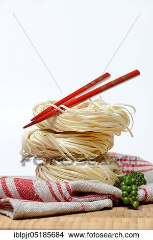 Chinese Yangchun noodles with chopsticks and green pepper, nest noodles View Large Photo Image Picture - Chinese Yangchun noodles with chopsticks and green pepper, nest noodles. Fotosearch