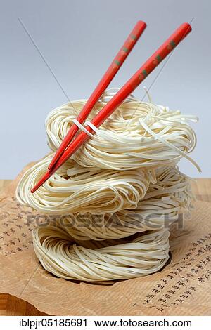 Chinese Yangchun noodles with chopsticks, uncooked, nest noodles View Large Photo Image Stock Image - Chinese Yangchun noodles with chopsticks, uncooked, nest noodles. Fotosearch