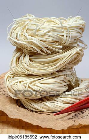 Chinese Yangchun noodles with chopsticks, uncooked, nest noodles View Large Photo Image Stock Image - Chinese Yangchun noodles with chopsticks, uncooked, nest noodles. Fotosearch