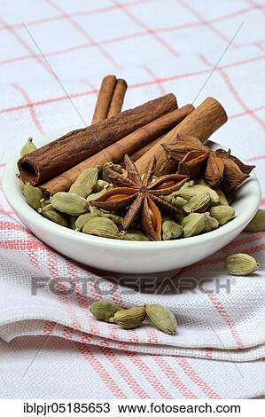 Christmas spices in bowl, cinnamon sticks( Elettaria cardamomum), star anise ( Illicium verum) View Large Photo Image Stock Image - Christmas spices in bowl, cinnamon sticks( Elettaria cardamomum), star anise ( Illicium verum). Fotosearch