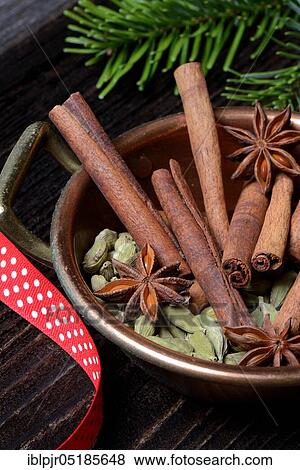 Stock Photo - Christmas spices in bowl, cinnamon sticks( Elettaria cardamomum), star anise ( Illicium verum). Fotosearch