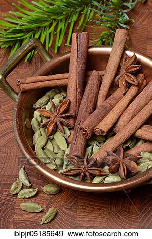 Christmas spices in bowl, cinnamon sticks( Elettaria cardamomum), star anise ( Illicium verum) View Large Photo Image Stock Photo - Christmas spices in bowl, cinnamon sticks( Elettaria cardamomum), star anise ( Illicium verum). Fotosearch