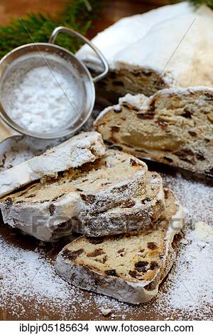 Christmas stollen and sieve with icing sugar View Large Photo Image Picture - Christmas stollen and sieve with icing sugar. Fotosearch