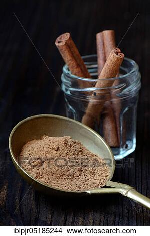 Cinnamonpowder ( Cinnamomum) in brass ladle and bars spec View Large Photo Image Picture - Cinnamonpowder ( Cinnamomum) in brass ladle and bars spec. Fotosearch