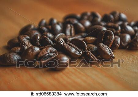 Coffee beans on wooden table View Large Photo Image Picture - Coffee beans on wooden table. Fotosearch