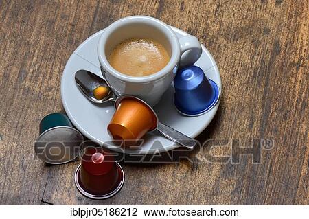 Stock Image - Coffee capsules and coffee cup with espresso. Fotosearch
