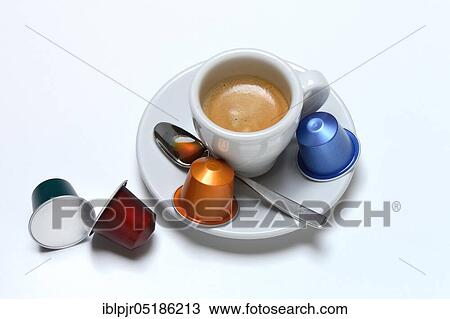 Stock Image - Coffee capsules and coffee cup with espresso. Fotosearch