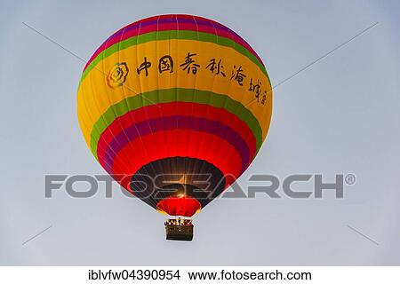 Colorful hot air balloon in the air, Vang Vieng, Vientiane Province, Laos, Asia View Large Photo Image Picture - Colorful hot air balloon in the air, Vang Vieng, Vientiane Province, Laos, Asia. Fotosearch