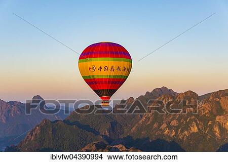 Colorful hot air balloon in the air, Karst Mountains behind, Vang Vieng, Vientiane Province, Laos, Asia View Large Photo Image Picture - Colorful hot air balloon in the air, Karst Mountains behind, Vang Vieng, Vientiane Province, Laos, Asia. Fotosearch