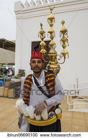 Stock Image - Colourful dressed traditional tea sekker, Al Janadriyah Festival, Riadh, Saudi Arabia, Asia. Fotosearch