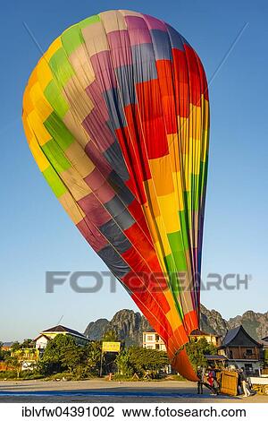 Colourful hot air balloon on ground after landing, Vang Vieng, Vientiane Province, Laos, Asia View Large Photo Image Stock Image - Colourful hot air balloon on ground after landing, Vang Vieng, Vientiane Province, Laos, Asia. Fotosearch