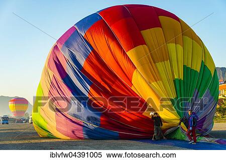 Colourful hot air balloon on ground after landing, Vang Vieng, Vientiane Province, Laos, Asia View Large Photo Image Stock Photography - Colourful hot air balloon on ground after landing, Vang Vieng, Vientiane Province, Laos, Asia. Fotosearch