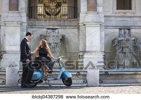 Couple sitting on a Vespa scooter at Fontana dell'Acqua Paola, Il Fontanone, Gianicolo Hill, Janiculum Hill, Rome, Italy, Europe View Large Photo Image Stock Photo - Couple sitting on a Vespa scooter at Fontana dell'Acqua Paola, Il Fontanone, Gianicolo Hill, Janiculum Hill, Rome, Italy, Europe. Fotosearch