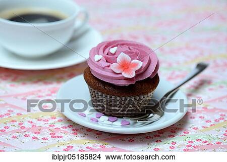 Picture - Cupcake on plate with cake fork. Fotosearch