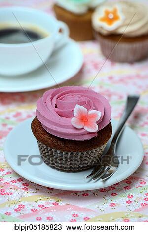 Cupcake on plate with cake fork View Large Photo Image Stock Image - Cupcake on plate with cake fork. Fotosearch