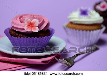 Stock Image - Cupcake on plate with cake fork. Fotosearch
