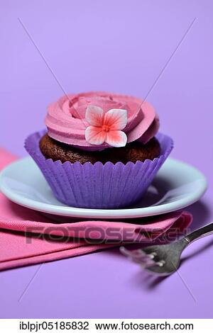 Stock Image - Cupcake on plate with cake fork. Fotosearch