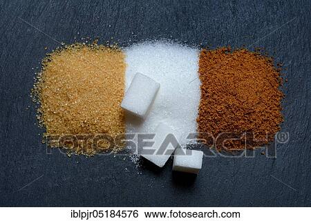Stock Photograph - Different kinds of sugar, cane sugar, white sugar and sugar cubes, palm sugar, sugar crystals, household sugar, brown sugar, granulated sugar, beet sugar. Fotosearch