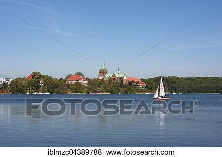 Stock Photo - Domsee lake with sailboat, Cathedral of Ratzeburg behind, Ratzeburg, Schleswig-Holstein, Germany, Europe. Fotosearch