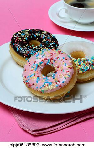 Donuts on plate and cup of coffee, candy, icing, sugar icing View Large Photo Image Stock Image - Donuts on plate and cup of coffee, candy, icing, sugar icing. Fotosearch