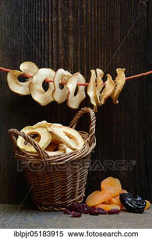 Stock Photography - Dried fruit, apple rings in baskets, apple rings on string, apricots, prunes and cranberries. Fotosearch