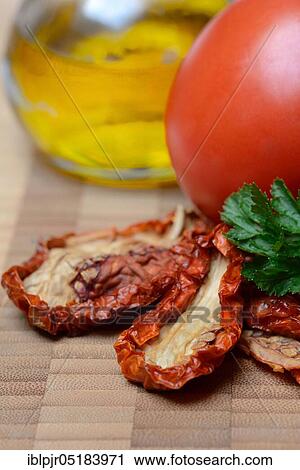 Stock Image - Dried tomatoes, antipasti, olive oil, oil. Fotosearch