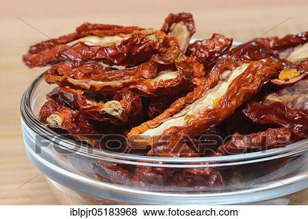 Stock Photo - Dried tomatoes in glass bowl, antipasti. Fotosearch