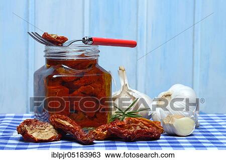 Dried tomatoes in jar with olive oil, antipasti, olive oil, garlic View Large Photo Image Stock Image - Dried tomatoes in jar with olive oil, antipasti, olive oil, garlic. Fotosearch
