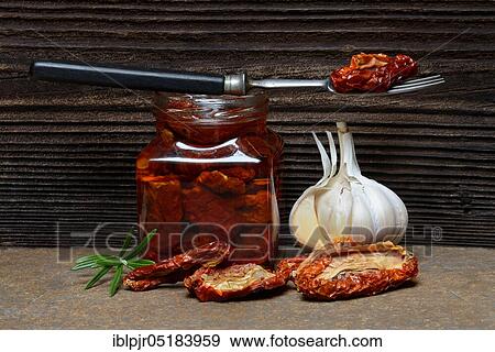 Dried tomatoes in jar with olive oil, antipasti, olive oil, garlic View Large Photo Image Stock Photo - Dried tomatoes in jar with olive oil, antipasti, olive oil, garlic. Fotosearch
