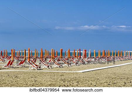 Empty orange deckchairs and sunshades on beach, early season, Viareggio, Tuscany, Italy, Europe View Large Photo Image Picture - Empty orange deckchairs and sunshades on beach, early season, Viareggio, Tuscany, Italy, Europe. Fotosearch