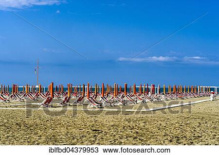 Empty orange deckchairs and sunshades on beach, early season, Viareggio, Tuscany, Italy, Europe View Large Photo Image Stock Image - Empty orange deckchairs and sunshades on beach, early season, Viareggio, Tuscany, Italy, Europe. Fotosearch