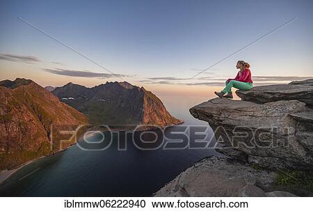 Evening atmosphere, hiker on top of Ryten, sea, Kvalvika beach and mountains, Fredvang, Lofoten, Nordland, Norway, Europe View Large Photo Image Stock Image - Evening atmosphere, hiker on top of Ryten, sea, Kvalvika beach and mountains, Fredvang, Lofoten, Nordland, Norway, Europe. Fotosearch