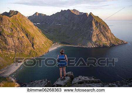 Evening atmosphere, hiker on top of Ryten, sea, Kvalvika beach and mountains, Fredvang, Lofoten, Nordland, Norway, Europe View Large Photo Image Stock Image - Evening atmosphere, hiker on top of Ryten, sea, Kvalvika beach and mountains, Fredvang, Lofoten, Nordland, Norway, Europe. Fotosearch