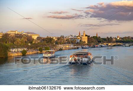 Excursion boat on the river Rio Guadalquivir, behind Torre del Oro, Seville, Andalusia, Spain, Europe View Large Photo Image Stock Photograph - Excursion boat on the river Rio Guadalquivir, behind Torre del Oro, Seville, Andalusia, Spain, Europe. Fotosearch