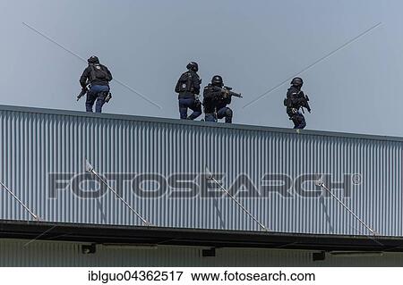 Stock Photo - Exercise of special operations group of Lucerne police Luchs with machine guns on roof, Switzerland, Europe. Fotosearch
