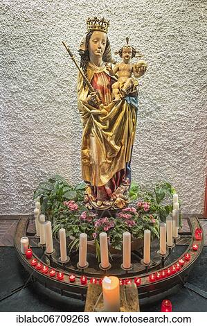 Figure of the Virgin Mary with baby Jesus and sacrificial candles, Church of St. John the Baptist, Ismaning, Upper Bavaria, Bavaria, Germany, Europe View Large Photo Image Stock Photo - Figure of the Virgin Mary with baby Jesus and sacrificial candles, Church of St. John the Baptist, Ismaning, Upper Bavaria, Bavaria, Germany, Europe. Fotosearch