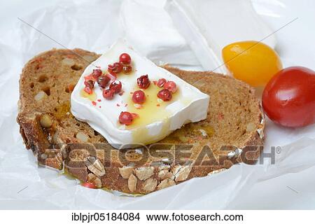 Picture - Goat cheese, on slice of bread, with berries, with olive oil, pepper. Fotosearch
