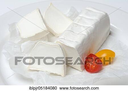 Stock Image - Goat cheese with cherry tomatoes, goat cheese. Fotosearch