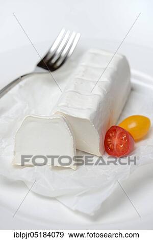 Stock Photo - Goat cheese with cherry tomatoes, goat cheese. Fotosearch