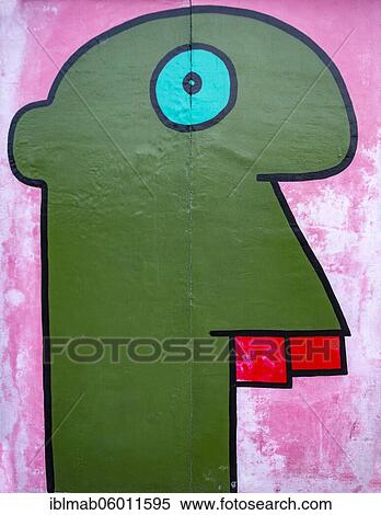 Graffiti homage to the young generation, colorful head in comic style, painting on the Berlin Wall, artist Thierry Noir, East Side Gallery, Berlin, Germany, Europe View Large Photo Image Stock Photography - Graffiti homage to the young generation, colorful head in comic style, painting on the Berlin Wall, artist Thierry Noir, East Side Gallery, Berlin, Germany, Europe. Fotosearch